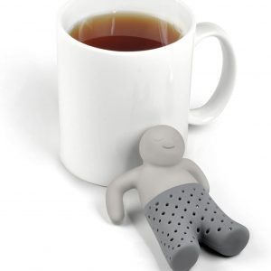 Genuine Fred MR. TEA Silicone Tea Infuser Sitting Next To Steaming Cup Of Tea