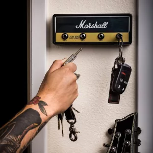Hand Plugging In Amp Key Into Marshall Wall Mounting Guitar amp Key Hanger