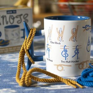 How To Knots Coffee Mug Product Shot With Box on Blue Table Cloth