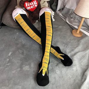 Woman Wearing Chicken Leg Socks On Bed