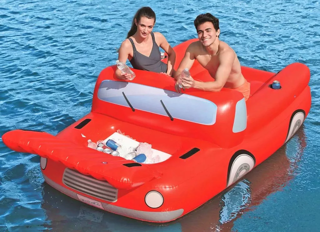 Couple Floating on Pickup Truck Pool Float With A Cooler Under The Hood With Hood Open