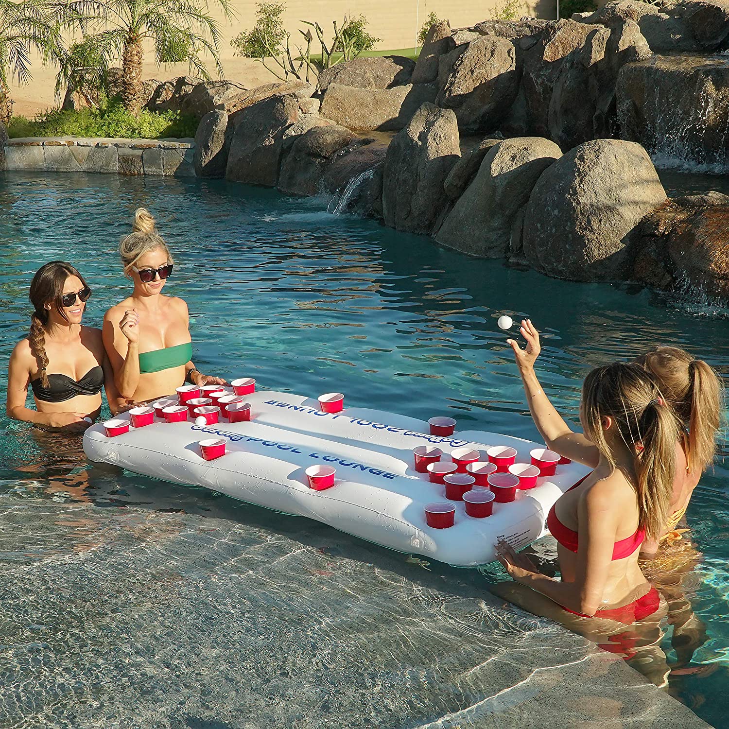 Group of Girls Playing Inflatable Floating Beer Pong Table in Lake