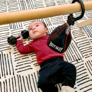Baby Laying Under Buff Baby Speed Bag Working Out