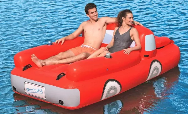 Couple Lounging on Pickup Truck Pool Float With A Cooler Under The Hood