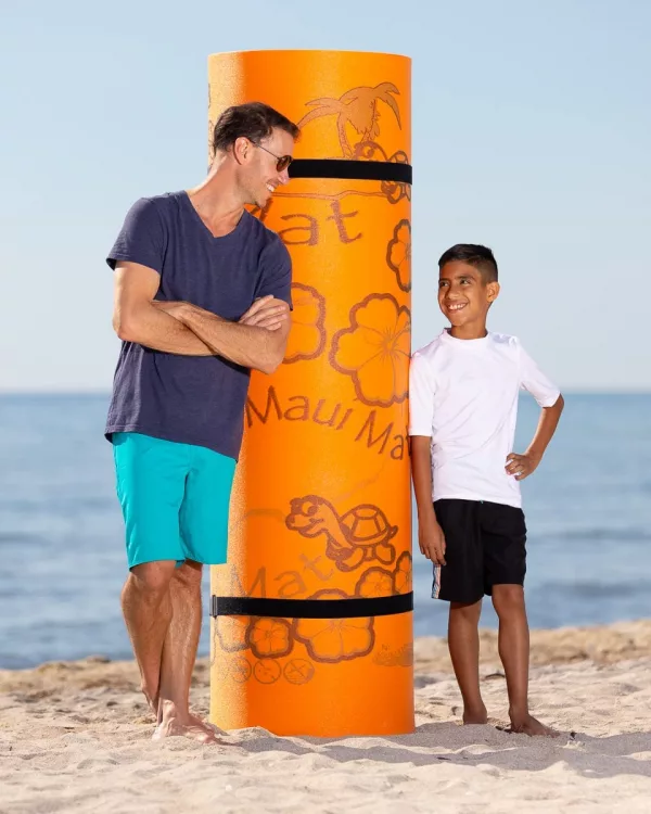 Father and Son Standing Next to Rolled Up Giant Water Mat