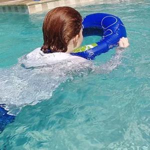 Girl Swimming With Snorkling Floating Device With A Sea Window