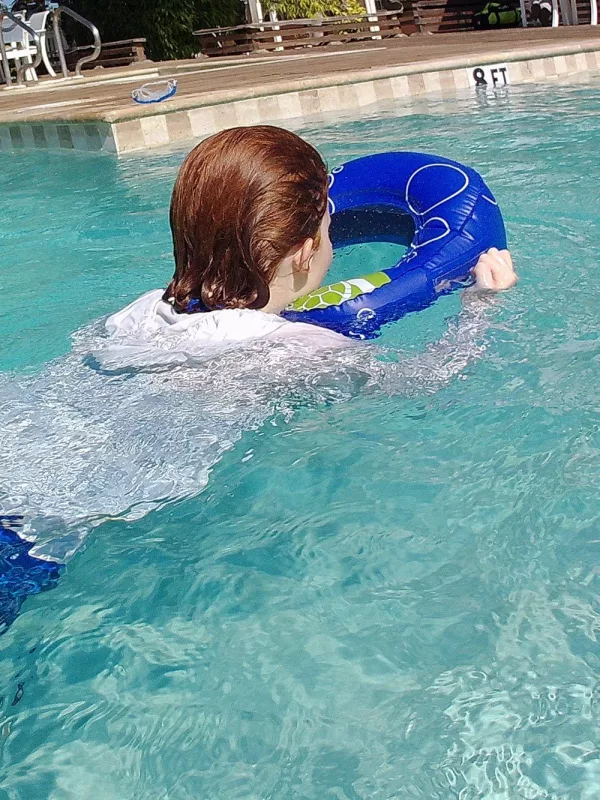 Girl Swimming With Snorkling Floating Device With A Sea Window