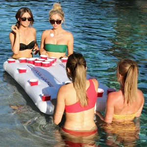Group of Girls Playing Inflatable Floating Beer Pong Table