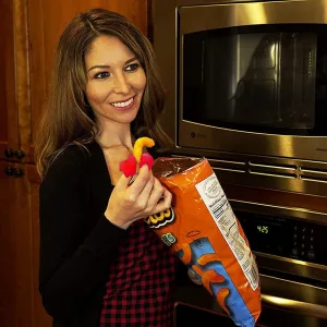 Woman Eating Cheetos Using Chip Finger Tips