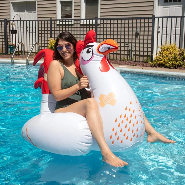 Woman Sitting On Chicken Fight Pool Toys in pool