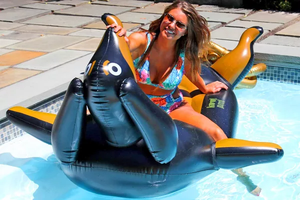 Woman Sitting On Giant Wiener Dog Pool Floats