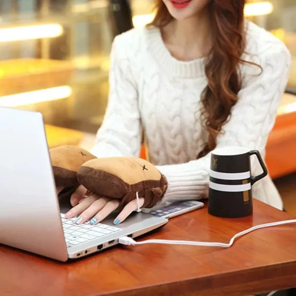 Woman typing on laptop wearing the Toast Shaped USB Heated Hand Warmers