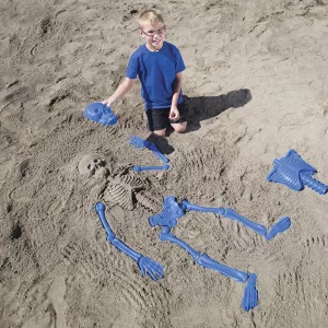 Young Kid playing in sand with Bag O'Beach Bones Playset