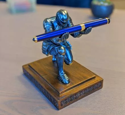 Bowing Knight Pen Holder Holding blue pen
